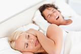 Annoyed woman awaken by her fiance's snoring