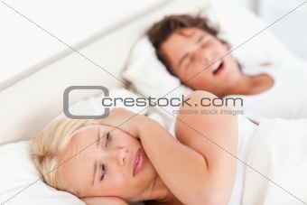 Annoyed woman awaken by her fiance's snoring