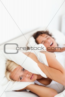 Portrait of a woman awaken by her husband's snoring