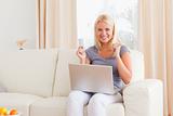 Woman cheering while buying online