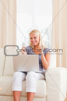 Portrait of a gorgeous blonde woman shopping online