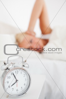 Alarmclock waking up a woman