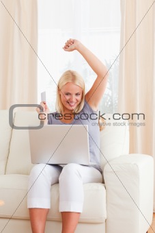 Portrait of a woman cheering while buying online