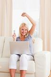 Portrait of a smiling blonde woman shopping online