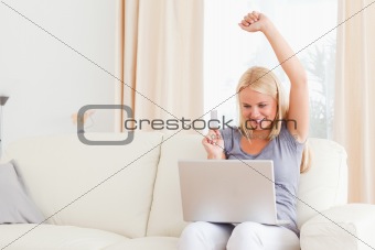 Smiling blonde woman buying online