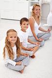 Kids doing yoga relaxation with their mother