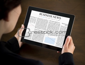 Business woman reading news on tablet pc