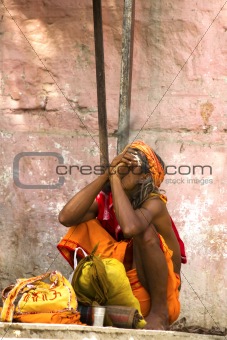 sadhu (holy man) smokes a pipe