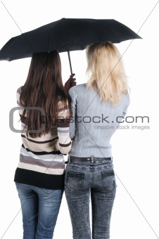 Two women under an umbrella. Rear view. 