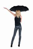 Blond young woman under an umbrella. Isolated over white.