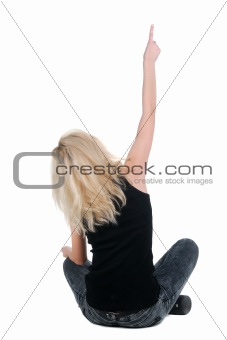 sitting young woman pointing. Rear view. isolated over white.