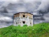 Old stone tower over cloudy sky
