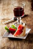 closeup of a ham sandwich and red wine