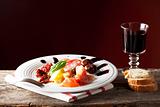 mixed italian antipasti on a plate with wine