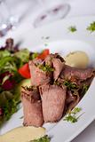 slices of roast beef with salad