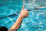 thumb up in the swimming pool