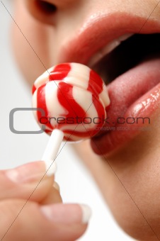Girl licking a lollipop
