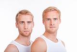 portrait of young twin brothers with blond hair and blue eyes - isolated on white
