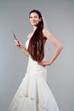 portrait of a bride with long dark hair in wedding dress - isolated on gray