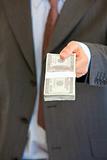 Businessman giving stack of dollars. Close-up.
