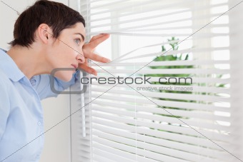 Woman peeking out a window