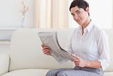 Beautiful brunette woman reading the news