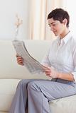 Portrait of a Beautiful brunette woman reading the news