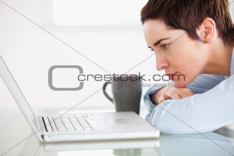 Cute woman with a laptop and a cup