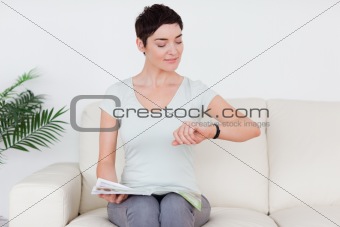 Smiling short-haired Woman with a magazine