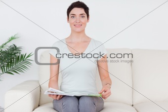 Brunette smiling Woman with a magazine