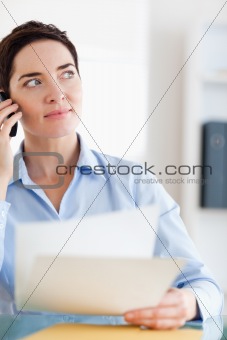Close up of a Businesswoman with papers on the phone