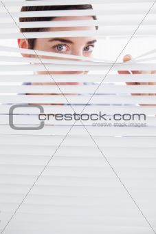 Curious Woman peeking out of a window