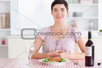 Woman sitting at a table with wine for lunch