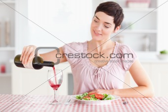 Woman pouring wine in a glass
