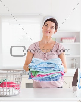 Charming Woman with a pile of clothes