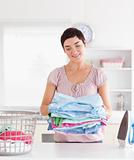 Smiling Woman with a pile of clothes