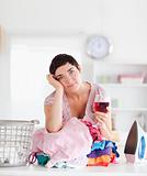 Brunette Woman with wine and a pile of clothes