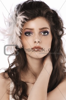 girl with long curled hairstyle and feather accessory 