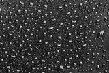 Rain droplets on a black plastic