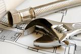 Plumbing tools on house blueprint