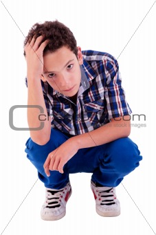 young man squatting, worried, isolated on white background studio shot