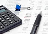 Financial report with calculator and pen