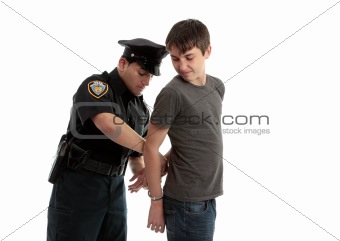 Policeman handcuffing teenager