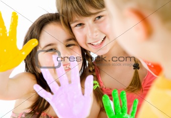 children painted hands playing