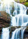 Waterfalls on Rocky Autumn Stream and sunshine