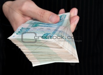 Hand holding boundle of roubles