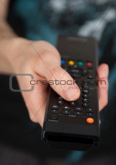 Hand holding TV remote control