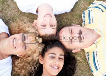 Happy family of four on grass