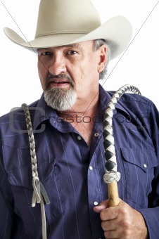 Cowboy with bullwhip ready to work
