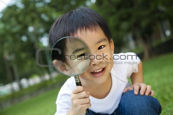 happy kid with magnifying glass